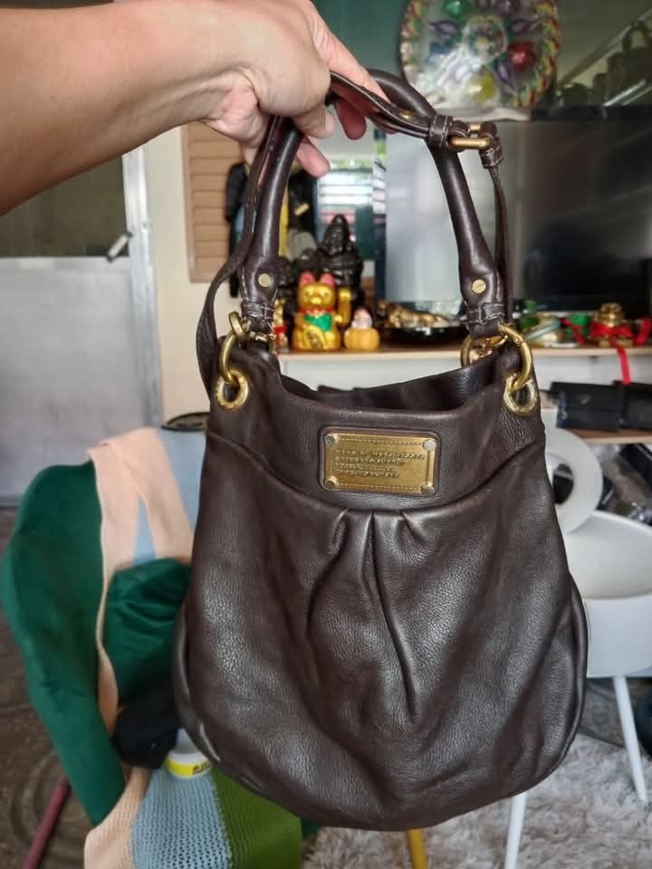 MarcJacobs brown (Category: Luxury Bags & Wallets) located in Angeles City. Submitted by mjshoppingretail (Listing ID 1396704433, Image 3). Description: - Authentic Marc by Marc Jacobs hobo bag - Brown leather - Classic design - Top handle and shoulder strap - Gold-tone hardware - Signature logo plate - High-quality leather - Stylish and functional.
