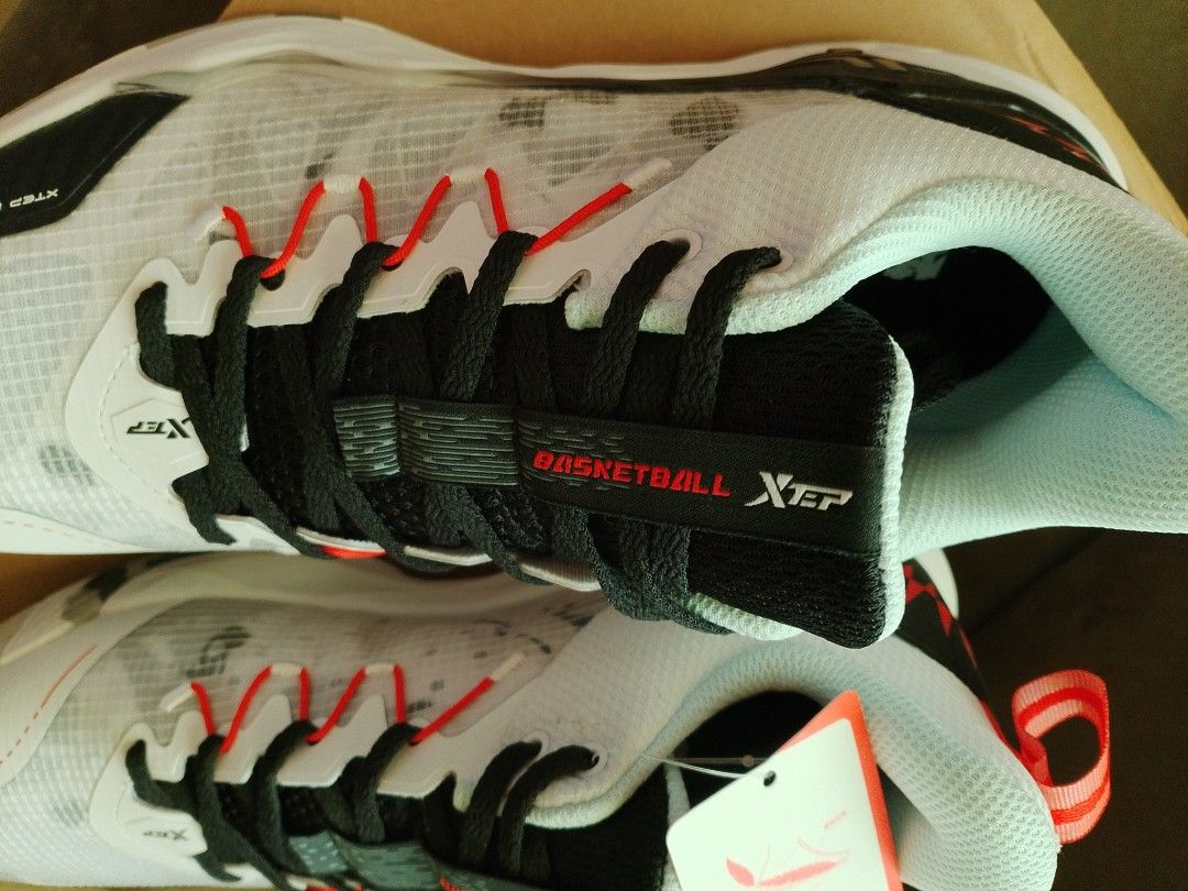 XTEP Basketball Shoes - White (Category: Sneakers) located in Subic. Submitted by davedelrosariome (Listing ID 1396765744, Image 3). Description: -Brand new / Never been worn / Never been used - XTEP basketball shoes - Color: White with black and red accents - Unique design with camouflage sole - Size: US 9.5, UK 8.5, EUR 43, CN 270 - Features black laces with red accents - XTEP logo visible on tongue and side - Includes original box and tags.