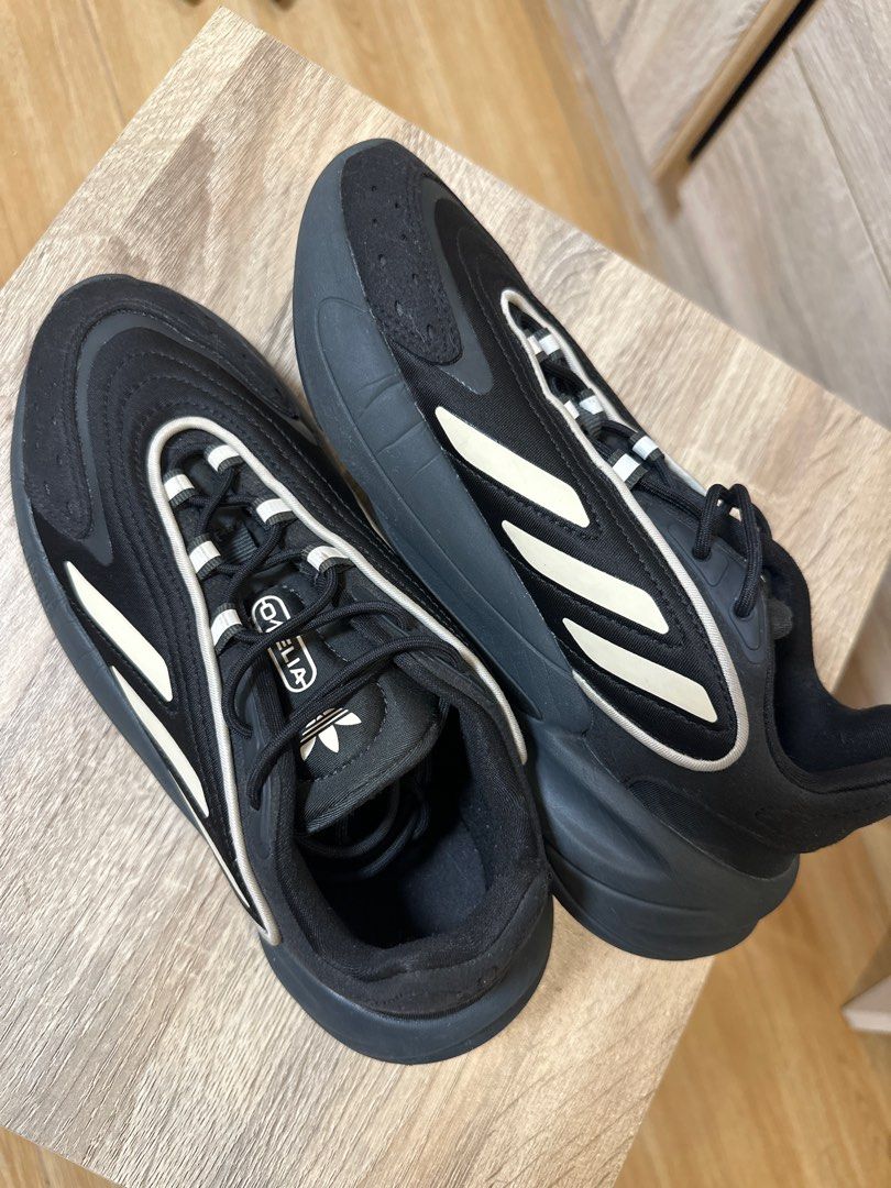 Adidas Ozelia Black Sneakers (Category: Sneakers) located in Marikina City. Submitted by samcmkhaye (Listing ID 1396953676, Image 2). Description: - Adidas Ozelia sneakers - Color: Black with white accents - Adidas logo on tongue and heel - Sole: Dark grey with 'adiprene' detail - Made in Cambodia - Lace-up closure - Size: 5 .