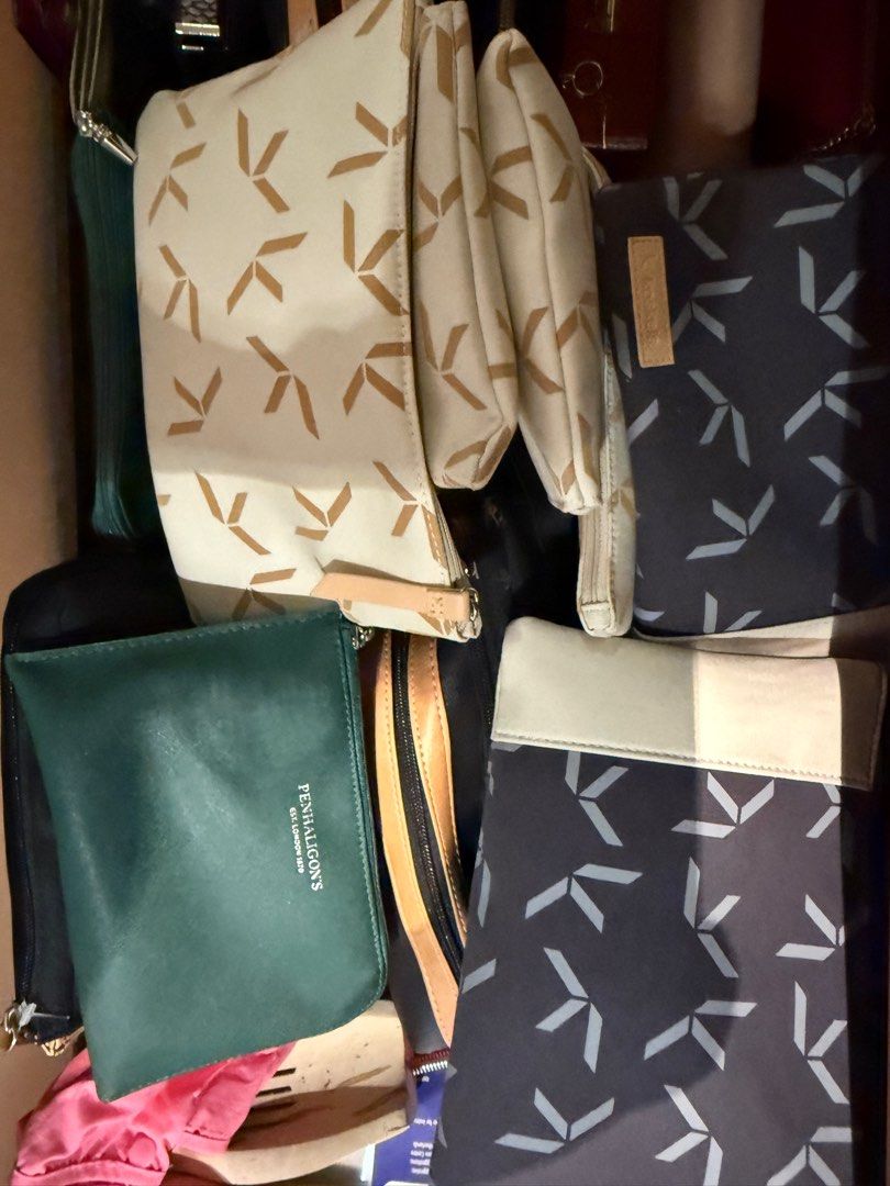 Assorted Cosmetic Bags business class first class (Category: Luxury Bags & Wallets) located in Pasig City. Submitted by declutter_z (Listing ID 1397015987, Image 3). Description: - Cosmetic bag collection - Includes: - Black rectangular bag with light purple handle - Silver bag - Black bag with tan accent - Green Penhaligon's cosmetic bag - Cream-colored bag with geometric pattern Dm for price per bag.