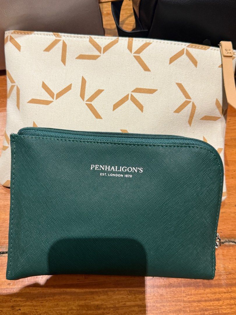 Assorted Cosmetic Bags business class first class (Category: Luxury Bags & Wallets) located in Pasig City. Submitted by declutter_z (Listing ID 1397015987, Image 2). Description: - Cosmetic bag collection - Includes: - Black rectangular bag with light purple handle - Silver bag - Black bag with tan accent - Green Penhaligon's cosmetic bag - Cream-colored bag with geometric pattern Dm for price per bag.