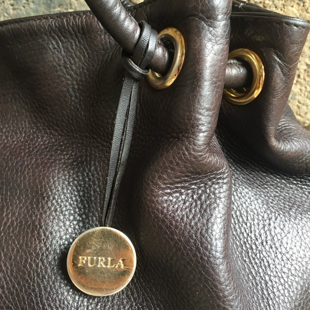 Authentic Furla Carmen Shoulder Bag (Category: Shoulder Bags) located in Marikina City. Submitted by arrveefm (Listing ID 1396851157, Image 3). Description: Authentic Furla Carmen Shoulder Bag Material: Genuine Leather Used but still in good condition (Check pictures for visible flaws; No Meet-ups; Payment thru BDO/GCash Color: Dark Brown Made in Tunisia Selling for Php 3,500.00 + Shipping Smooth leather, magnetic closure. Interior pockets - one 