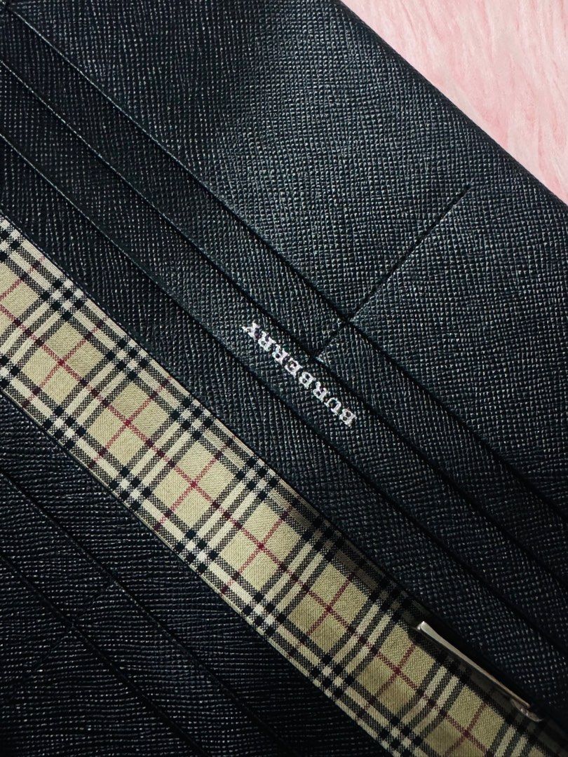 Burberry Black Leather Wallet (Category: Luxury Bags & Wallets) located in Manila. Submitted by ewikamiy (Listing ID 1396866595, Image 3). Description: - Genuine Burberry wallet - Black leather exterior - Signature Burberry check lining - Interior branding and zipper detail - Multiple card slots and bill compartments - Made with high-quality materials - Sleek and stylish design.