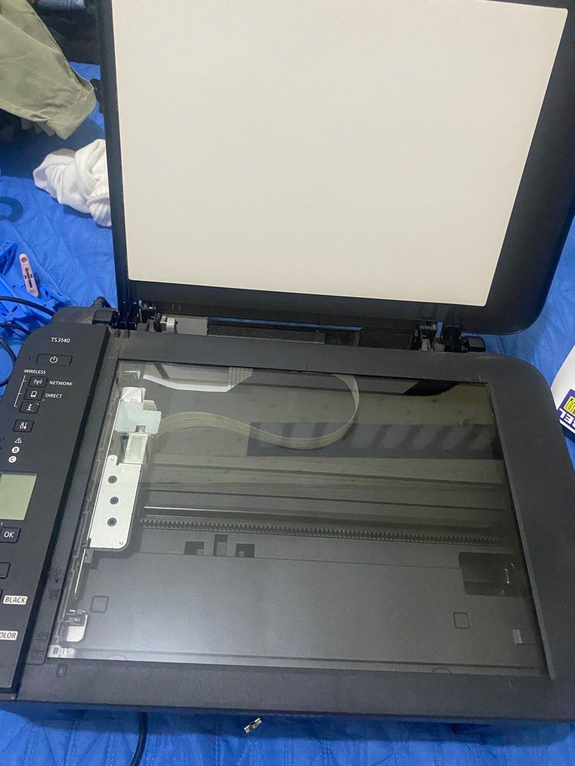 Canon PIXMA TS3140 Printer (Category: Printers, Scanners & Copiers) located in Manila. Submitted by eli024 (Listing ID 1396896080, Image 3). Description: - Canon PIXMA TS3140 printer - Wireless, network, and direct printing - Built-in scanner - Color and black printing options - Power and OK buttons - Top cover opens.