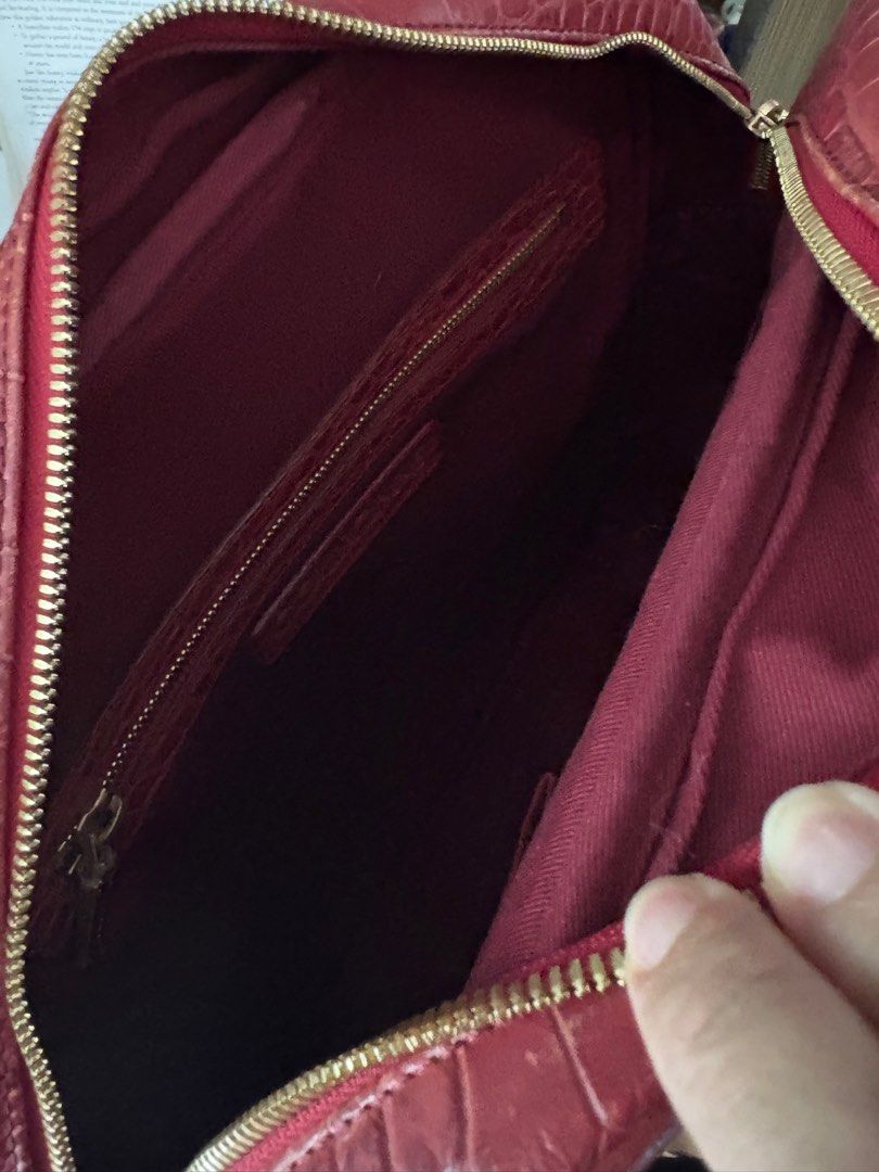 Couronne Red Croc-Embossed Backpack (Category: Luxury Bags & Wallets) located in Cavite. Submitted by misa_destash (Listing ID 1396866641, Image 3). Description: Couronne handbag features a red croc-embossed exterior with gold-tone hardware. It has a top handle and a detachable backpack straps. The interior includes a zippered pocket. The bag has a gold-tone lock with the Couronne logo. The bag has a rectangular shape with a zipper closure. Authe