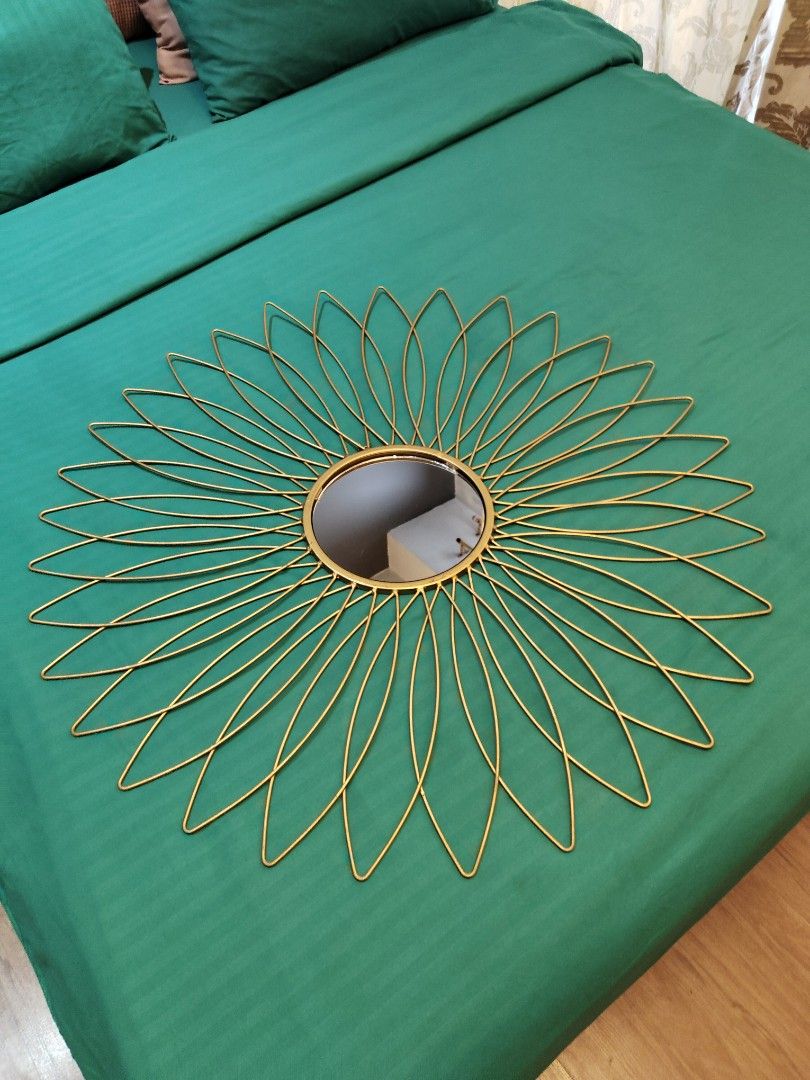 Gold Metal Sunflower Wall Mirror (Category: Mirrors) located in Makati City. Submitted by theseasonstrend (Listing ID 1396880137, Image 2). Description: - Gold metal sunflower wall mirror - Circular mirror with delicate metal petals - Adds sophistication to any space - Ideal for living rooms, bedrooms, or entryways - Easy to hang - Beautiful decorative piece.