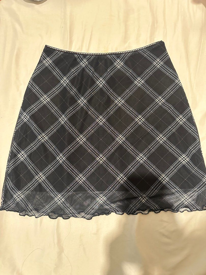 H&M Divided Plaid Mini Skirt (Category: Skirts) located in Manila. Submitted by cchaiprincess (Listing ID 1396978371, Image 1). Description: > cash first MOP: gcash rfs: not my style anymore - H&M Divided mini skirt - Classic plaid pattern - Black base with white and light blue grid lines - Wavy hemline - Black lining - Size: XS - Versatile for different outfits.