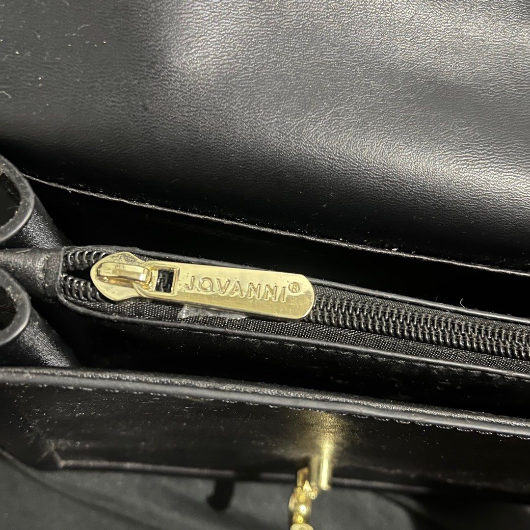Jovanni Black Handbag (Category: Luxury Bags & Wallets) located in Manila. Submitted by yap11111 (Listing ID 1396970099, Image 2). Description: - Jovanni black handbag - Gold-tone clasp and zipper - Interior zippered pocket - Structured design - Top handle - Made of leather or leather-like material.