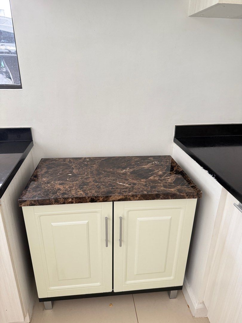 Kitchen Cabinet with Marble Top (Category: Shelves, Cabinets & Racks) located in Quezon City. Submitted by julybaby_31 (Listing ID 1396981547, Image 1). Description: - Cream-colored kitchen cabinet - Stylish marble top - Two doors - Two shelves for storage - Silver handles - Ready for use - Ideal for extra kitchen storage.