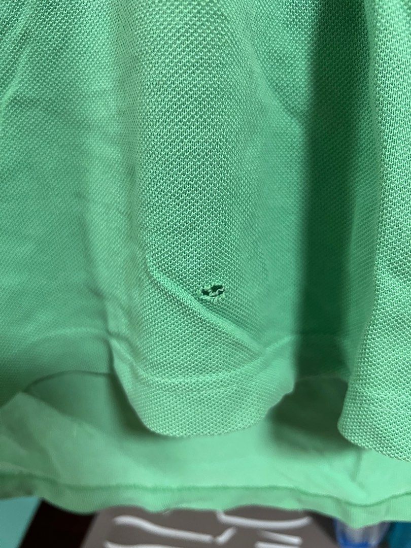 Lacoste Polo Shirt - Green (Category: Tshirts & Polo Shirts ) located in Muntinlupa City. Submitted by ms_shopph (Listing ID 1396910645, Image 3). Description: - Lacoste polo shirt - Size 8 - Color block design - Lacoste logo on chest - Number 27 on sleeve - Small hole near bottom hem - Collared neckline with button closure.