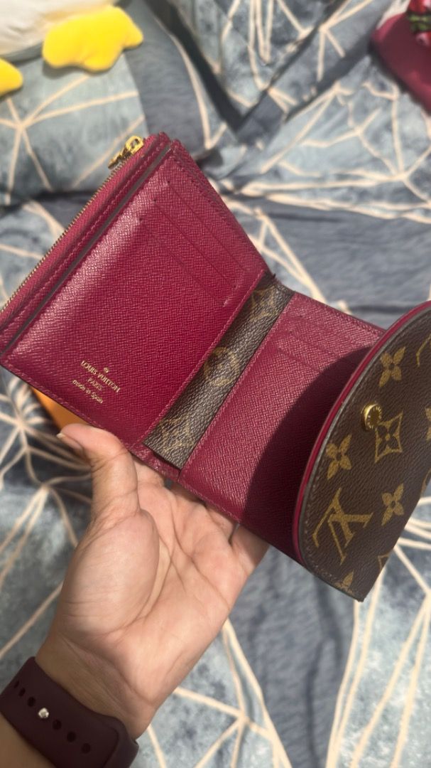 Louis Vuitton - Monogram Canvas Ariane Wallet (Category: Luxury Bags & Wallets) located in Cabuyao City. Submitted by grae__ (Listing ID 1396999759, Image 2). Description: - Authentic Louis Vuitton wallet - Iconic monogram canvas - Snap closure - Pink trim - Gold-toned hardware - Red interior - Zippered compartment - Card slots - Comes with box and legit grails. Has minor scratches in snap button and minor cracks in rubber sealing..