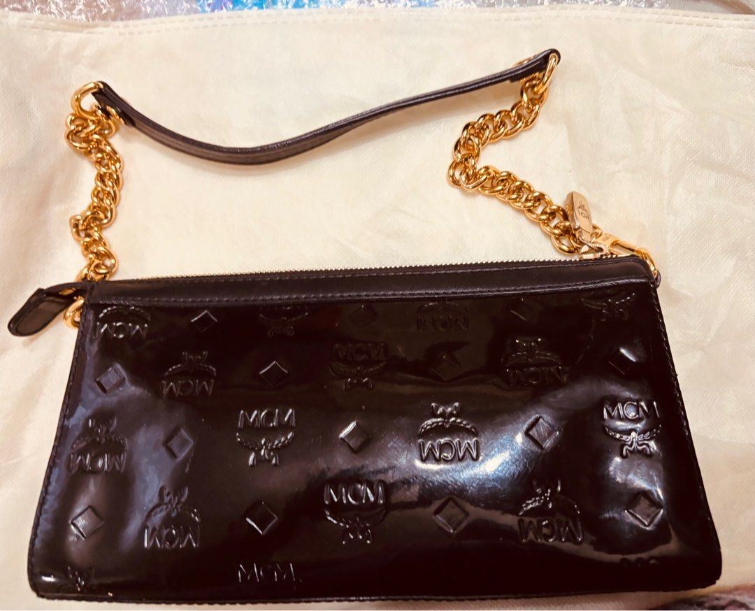 MCM clutch/shoulder bag (Category: Luxury Bags & Wallets) located in Indang. Submitted by lornacmtl (Listing ID 1396941669, Image 2). Description: MCM black patent bag , gold hardware, removable strap, 1 zip pocket , 1 open pocket & 4 card pockets, 9”x51/2”x2, with plastic pa the logomade in Korea Payment thru gcash.