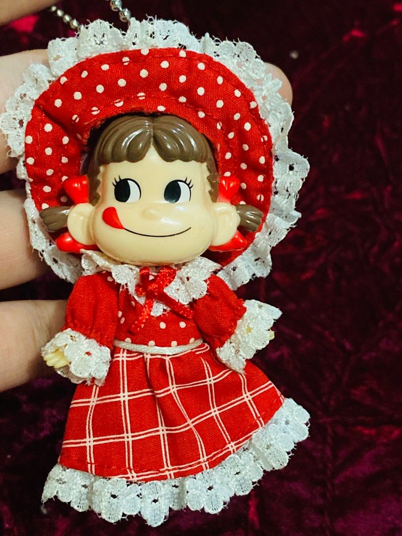 Peko Doll Keychain 250 (Category: Vintage Collectibles) located in Zamboanga. Submitted by kawaii_omocha_est2020 (Listing ID 1396962318, Image 1). Description: - Vintage Japanese girl doll keychain - Features a doll in a red dress with white lace trim - Matching hat included - Doll has a cute expression - Charming collectible item ✅Mine now/ Pay now ✅ Please scan all photos for more details. ✅ Manage your expectation. Most of items are preloved. 