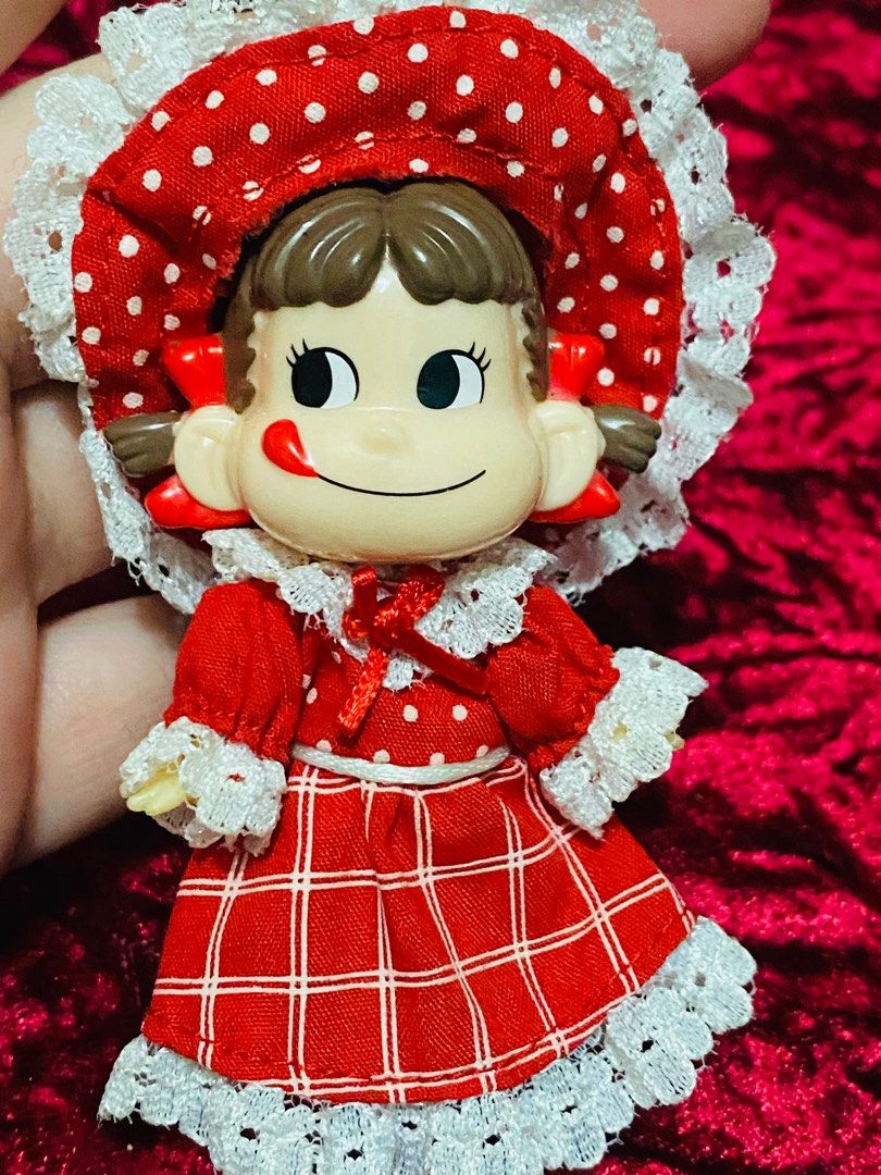 Peko Doll Keychain 250 (Category: Vintage Collectibles) located in Zamboanga. Submitted by kawaii_omocha_est2020 (Listing ID 1396962318, Image 2). Description: - Vintage Japanese girl doll keychain - Features a doll in a red dress with white lace trim - Matching hat included - Doll has a cute expression - Charming collectible item ✅Mine now/ Pay now ✅ Please scan all photos for more details. ✅ Manage your expectation. Most of items are preloved. 