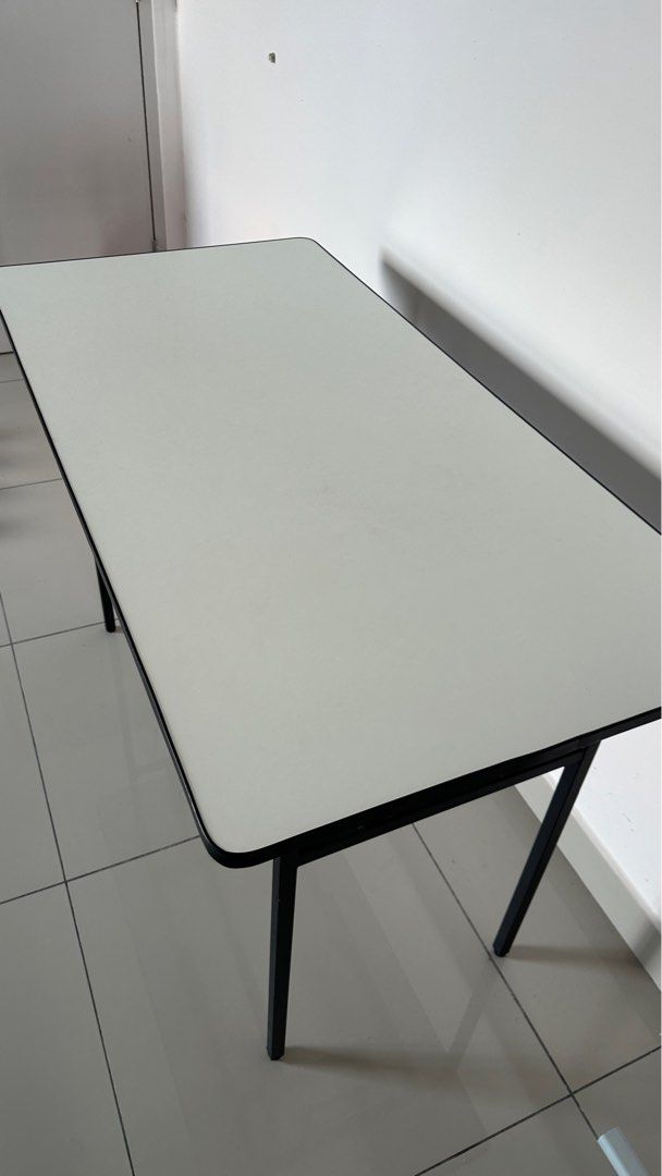 Rectangular Folding Table (Category: Tables & Sets) located in Sepang. Submitted by farxsm (Listing ID 1396900969, Image 3). Description: - White rectangular tabletop with black border - Sturdy black metal frame and legs - Foldable design for easy storage - Ideal for study, work, or temporary use Sepang or can lalamove, buyer cost.