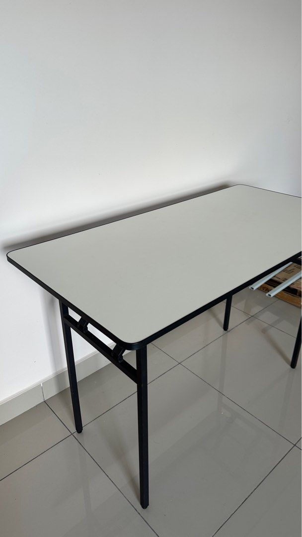 Rectangular Folding Table (Category: Tables & Sets) located in Sepang. Submitted by farxsm (Listing ID 1396900969, Image 1). Description: - White rectangular tabletop with black border - Sturdy black metal frame and legs - Foldable design for easy storage - Ideal for study, work, or temporary use Sepang or can lalamove, buyer cost.