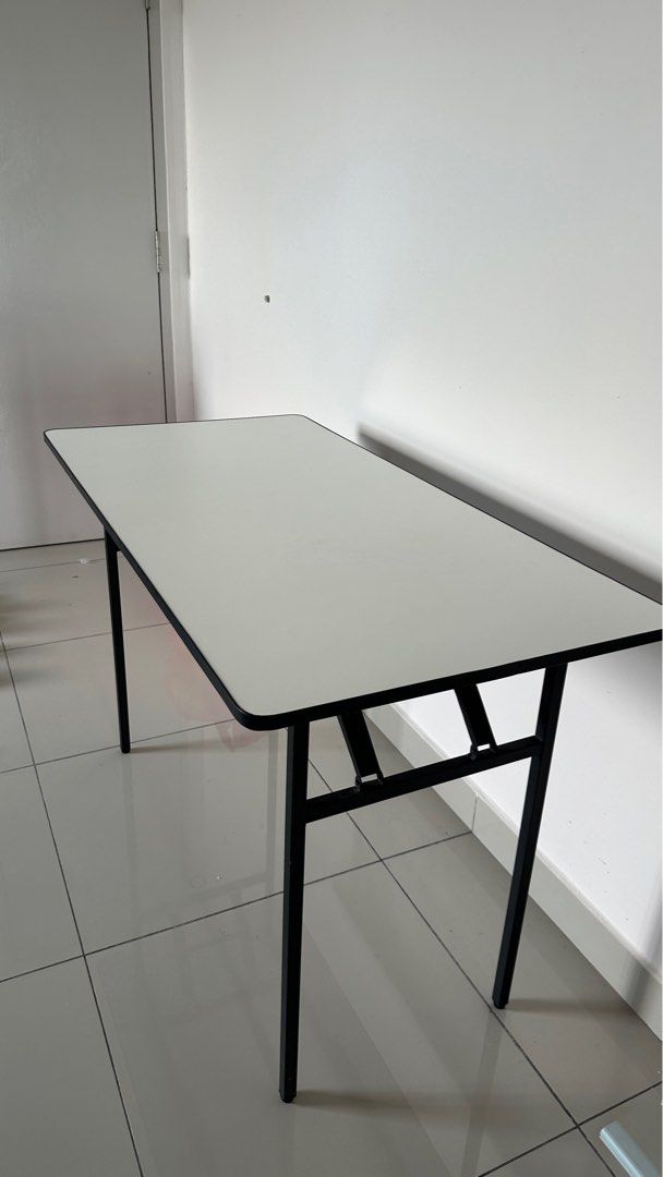 Rectangular Folding Table (Category: Tables & Sets) located in Sepang. Submitted by farxsm (Listing ID 1396900969, Image 2). Description: - White rectangular tabletop with black border - Sturdy black metal frame and legs - Foldable design for easy storage - Ideal for study, work, or temporary use Sepang or can lalamove, buyer cost.