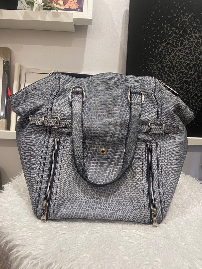 Saint Laurent Downtown Navy Blue shoulder bag (Category: Luxury Bags & Wallets) located in Subic. Submitted by dani70 (Listing ID 1396915237, Image 1). Description: - Authentic Saint Laurent Downtown handbag - Color: blue gray textured python embossed leather - Textured exterior - Double top handles - Multiple zippered compartments - Silver-tone hardware - Snap closure - Structured shape - Spacious interior - Bottom has two snap closures - sign o
