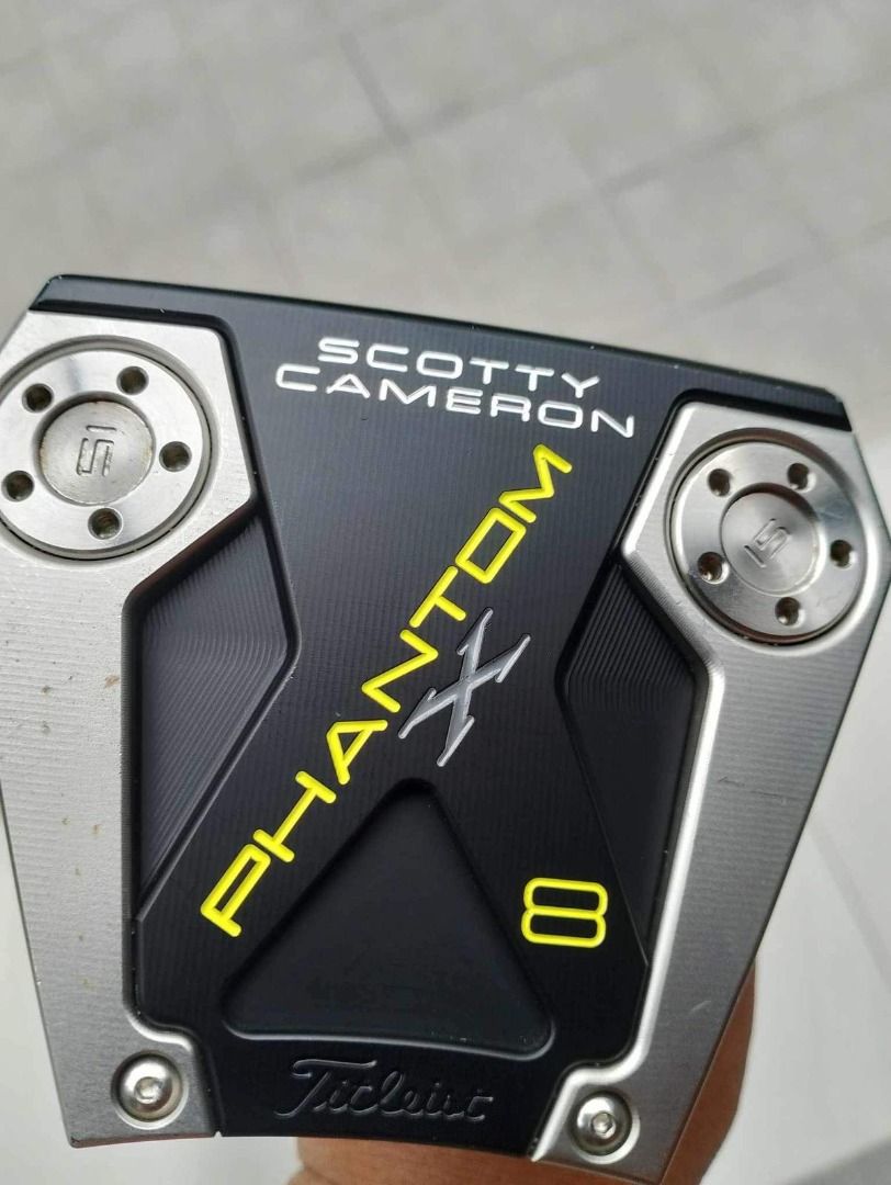 Scotty Cameron Phantom X 8 Putter (Category: Golf) located in Manila. Submitted by travis1894 (Listing ID 1396892788, Image 1). Description: - Scotty Cameron Phantom X 8 putter - Stylish black and silver design with yellow accents - Features the iconic Titleist logo - Model number '8' is clearly visible - Unique putter shape with distinctive screws.
