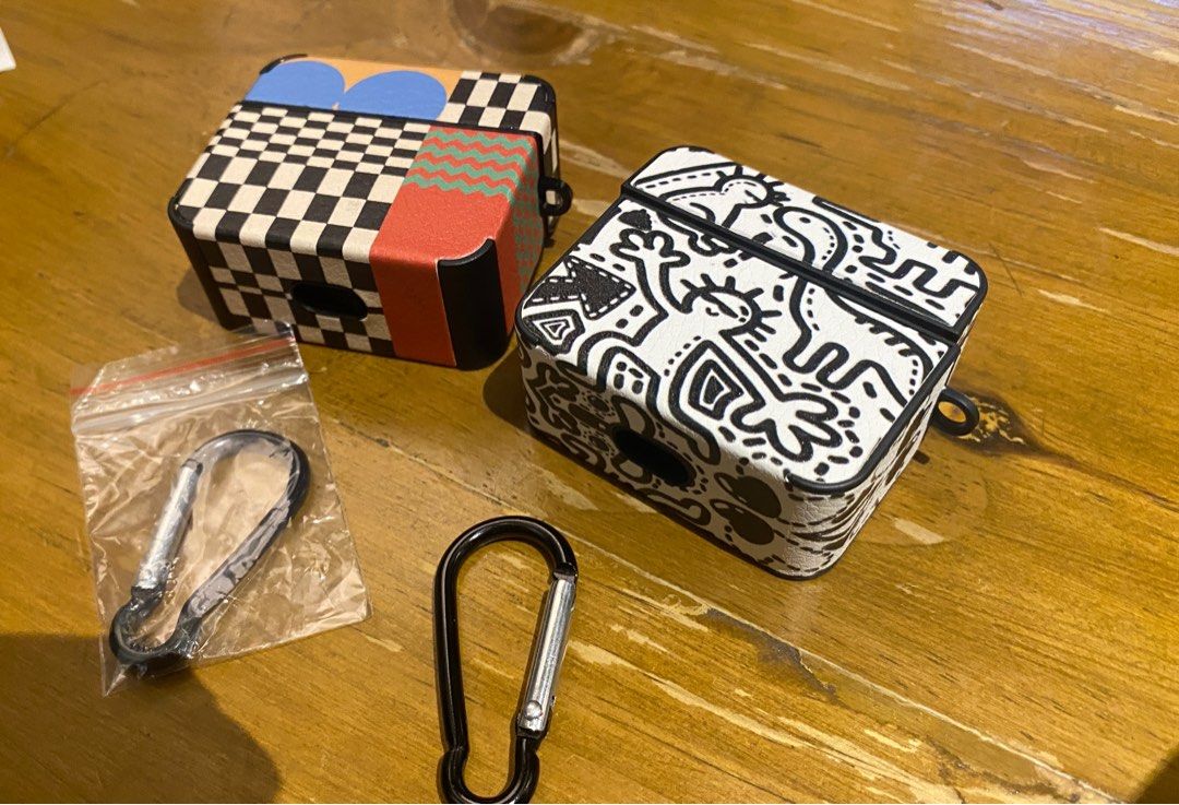 AirPods Case with Carabiner (Category: Earphones) located in Mandaluyong City. Submitted by offlegitstore (Listing ID 1397128243, Image 2). Description: - Stylish AirPods case - Available in two designs: black & white and colorful geometric - Includes a carabiner for easy attachment - Protects your AirPods -Price listed is for 1; buy both for a discounted price.