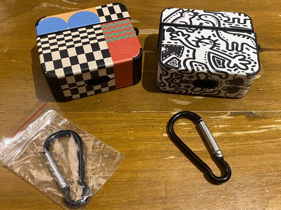 AirPods Case with Carabiner (Category: Earphones) located in Mandaluyong City. Submitted by offlegitstore (Listing ID 1397128243, Image 1). Description: - Stylish AirPods case - Available in two designs: black & white and colorful geometric - Includes a carabiner for easy attachment - Protects your AirPods -Price listed is for 1; buy both for a discounted price.