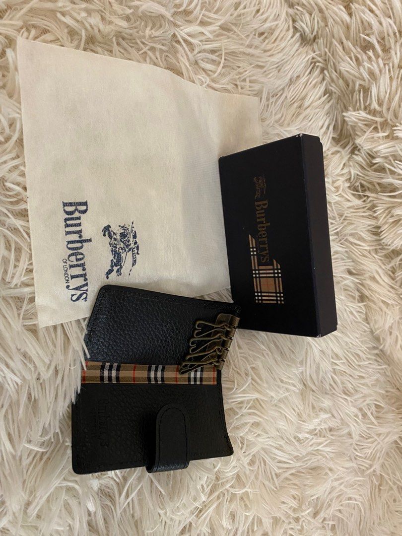 Burberrys Key Holder (Category: Luxury Bags & Wallets) located in Manila. Submitted by star_section (Listing ID 1397157162, Image 2). Description: - Authentic Burberry key holder - Black leather exterior - Burberry check pattern interior lining - Multiple key hooks - Snap closure - Includes original box - Includes dust bag - Stylish and functional.