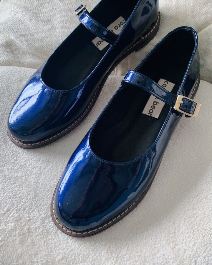 Cora & Bear Mary Jane Shoes (Category: Flats & Sandals) located in Makati City. Submitted by stef.vee (Listing ID 1397187241, Image 1). Description: - Nona Sapphire Genuine Patent Leather Mary Jane shoes - Brand: Cora & Bear - Features a strap with a gold buckle - Glossy finish - Stitched sole.