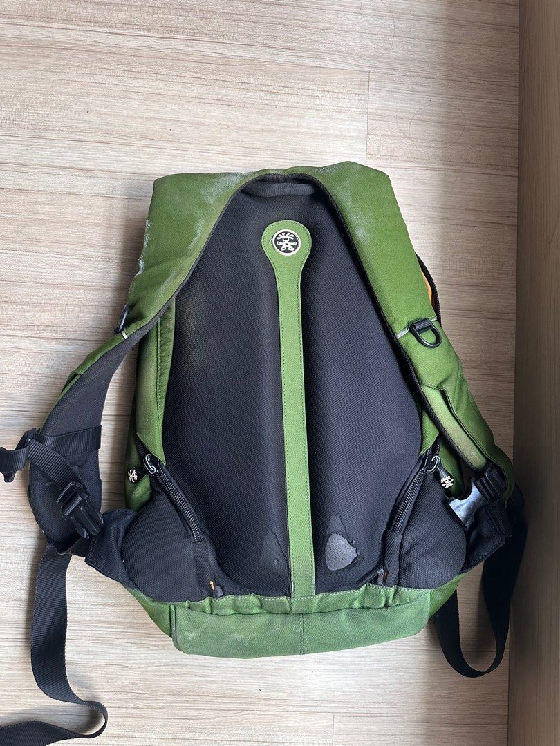 Crumpler Backpack (Category: Backpacks) located in Petaling Jaya. Submitted by fairulhilmi (Listing ID 1397192639, Image 3). Description: - Green Crumpler backpack (2007 model) - Main compartment with orange interior and mesh pocket - Padded back support - Adjustable straps - Small front zippered pocket - Unique design with central flap - Crumpler logo detailing - heavily used, now using Goruck & Evergoods for EDC - internal detachable laptop sle