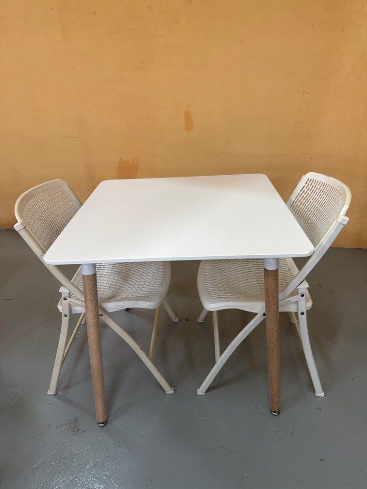 Dining Table Set (Category: Tables & Sets) located in Singapore. Submitted by edward_lcf_furniture_store (Listing ID 1397111859, Image 1). Description: Brand new 80cm square dining table White top with wooden leg comes with 2 white folding chair Diaplay set clearance One corner of table have a knock Selling this set for $90 with free delivery so no nego pls.