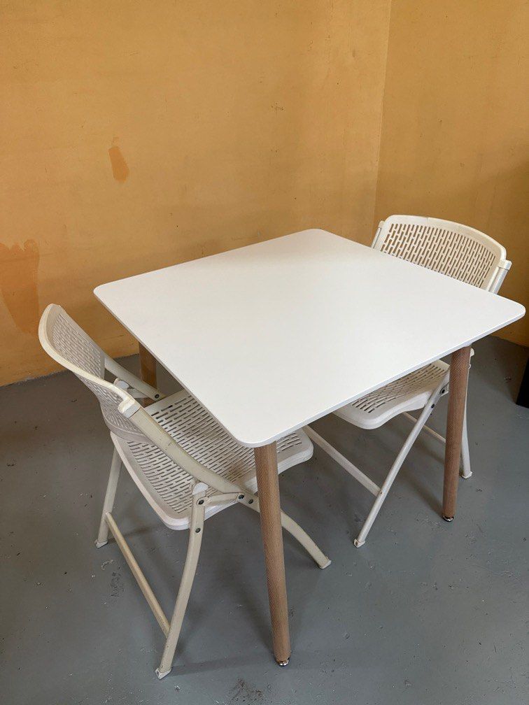 Dining Table Set (Category: Tables & Sets) located in Singapore. Submitted by edward_lcf_furniture_store (Listing ID 1397111859, Image 3). Description: Brand new 80cm square dining table White top with wooden leg comes with 2 white folding chair Diaplay set clearance One corner of table have a knock Selling this set for $90 with free delivery so no nego pls.