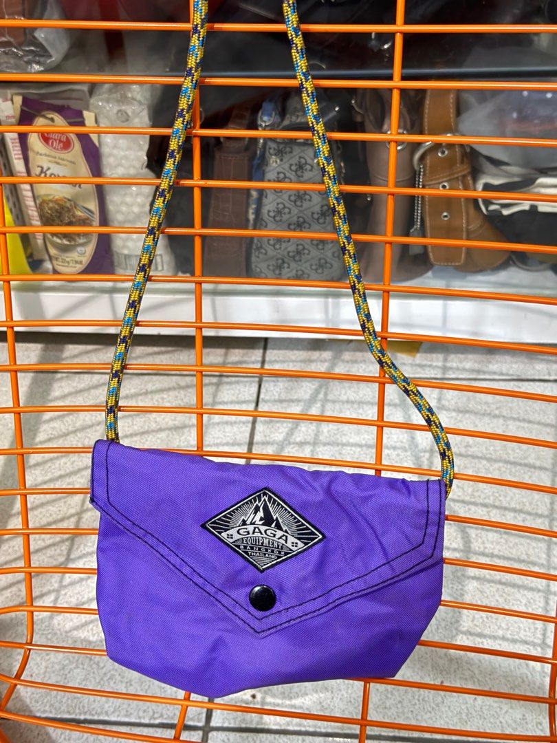 Gaga Equipment Crossbody Bag (Category: Cross-body Bags) located in Manila. Submitted by ccb123 (Listing ID 1397109074, Image 1). Description: - Purple crossbody bag - Black button closure - Features Gaga Equipment logo - Colorful rope strap - Durable, possibly water-resistant material - Perfect for carrying essentials READ FIRST BEFORE ASKING QUESTIONS: DO NOT BUY HERE IF YOU ARE PICKY AND DO NOT WANT TO WASH / CLEAN THE ITEMS. EXPECT SIGNS OF U
