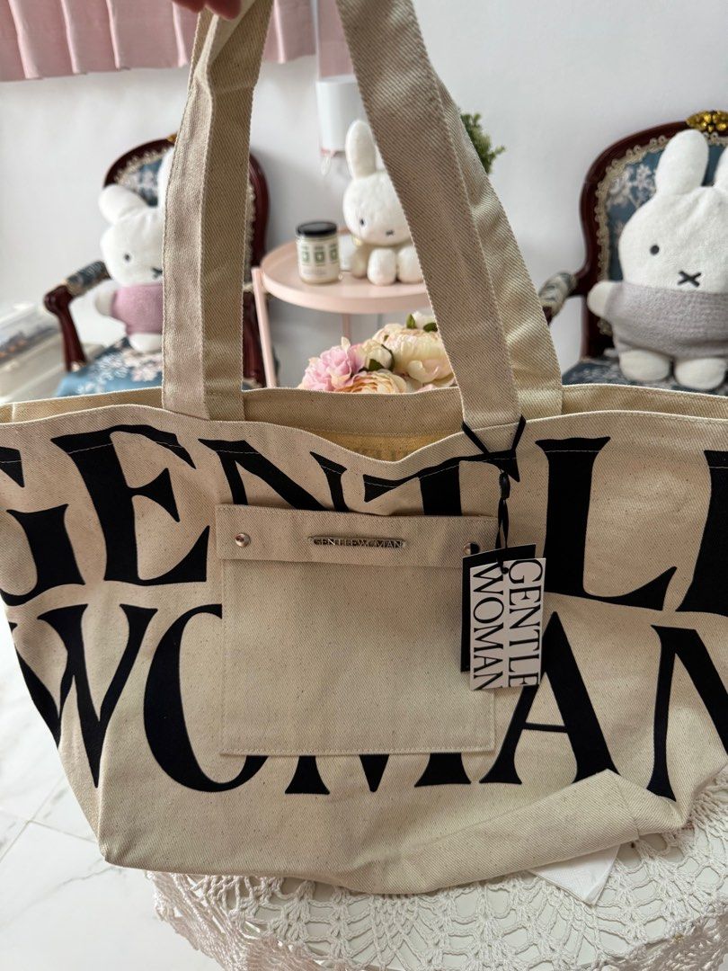 Gentlewoman Tote Bag (Category: Tote Bags) located in Marikina City. Submitted by bee031297 (Listing ID 1397098672, Image 1). Description: - Gentlewoman tote bag - Neutral color - Large front pocket - Brand name printed on front - Includes tag - Two handles.