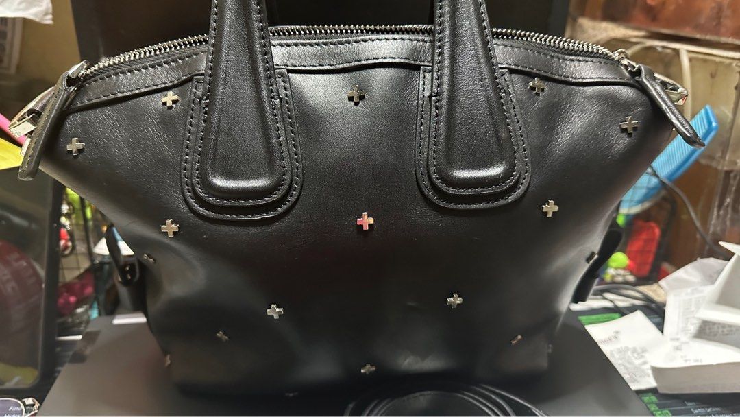 Givenchy Antigona Small Crossbody Bag (Category: Luxury Bags & Wallets) located in Taytay. Submitted by jp4_fashion_hub (Listing ID 1397071262, Image 2). Description: - Givenchy Antigona Small crossbody bag - Black color - Silver-tone hardware with cross studs - Detachable shoulder strap - Interior zip pocket - Givenchy label inside - Top zip closure - Dual top handles - Serial number: 12B0137.
