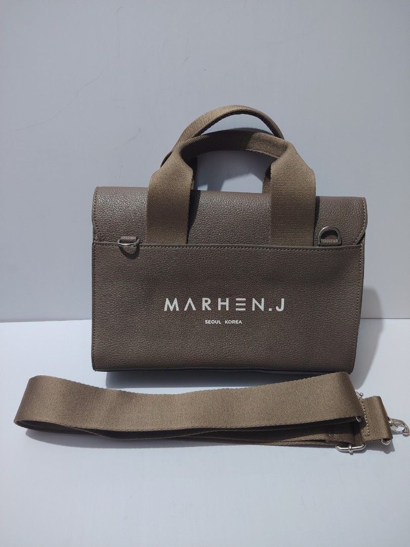 Marhen.J Seoul Korea Mini Bag (Category: Luxury Bags & Wallets) located in Valenzuela. Submitted by ryu12 (Listing ID 1397104709, Image 2). Description: - Mini handbag - Neutral brown color - Flap closure - Detachable shoulder strap - Top handle - Brand name printed on front - Single interior compartment - Fits phone and wallet.
