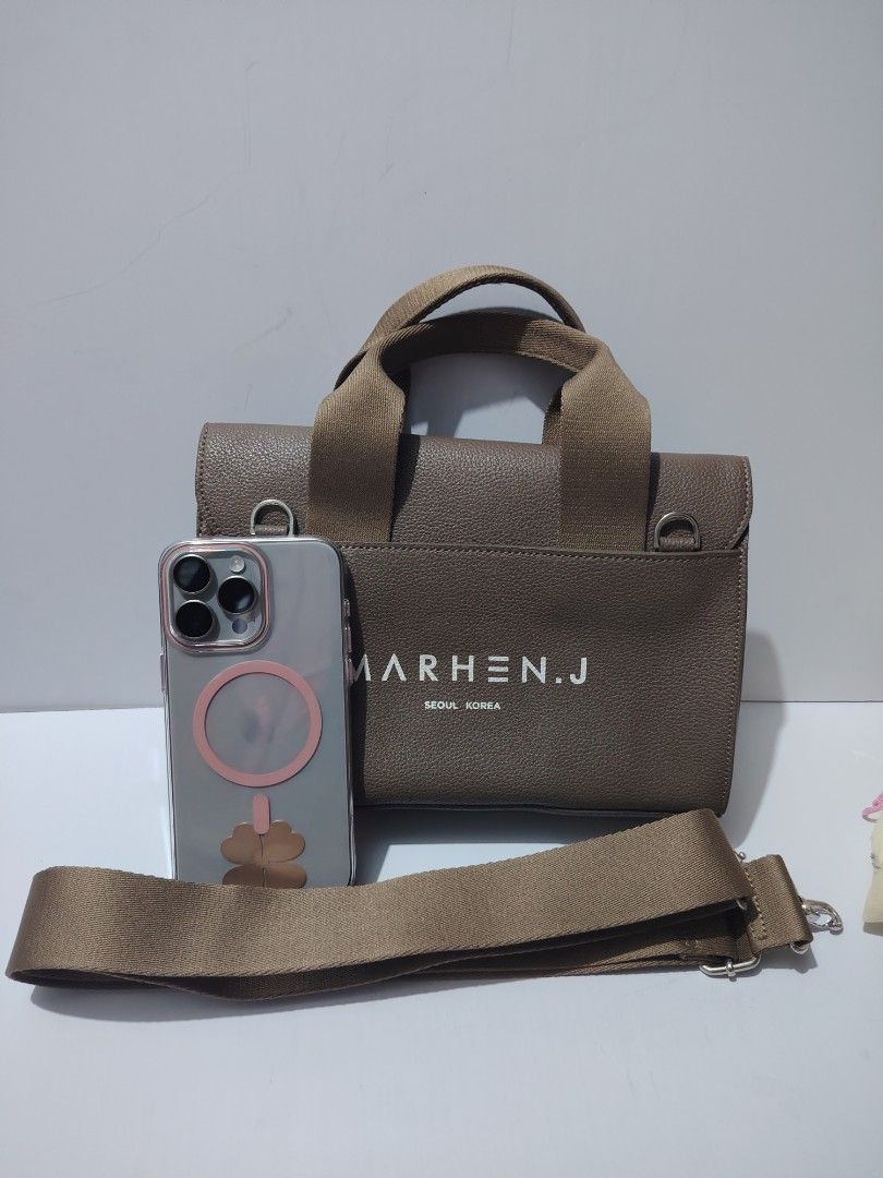 Marhen.J Seoul Korea Mini Bag (Category: Luxury Bags & Wallets) located in Valenzuela. Submitted by ryu12 (Listing ID 1397104709, Image 3). Description: - Mini handbag - Neutral brown color - Flap closure - Detachable shoulder strap - Top handle - Brand name printed on front - Single interior compartment - Fits phone and wallet.