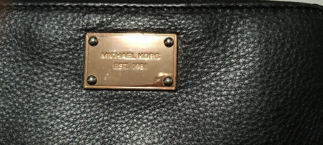 Michael Kors Zip Around Wallet (Category: Wallets & Card holders) located in Calamba. Submitted by mel013 (Listing ID 1397054136, Image 1). Description: - Michael Kors black zip-around wallet - Gold-tone metal plate and zipper - Features 'EST. 1981' - Multiple card slots and compartments - Made of leather.