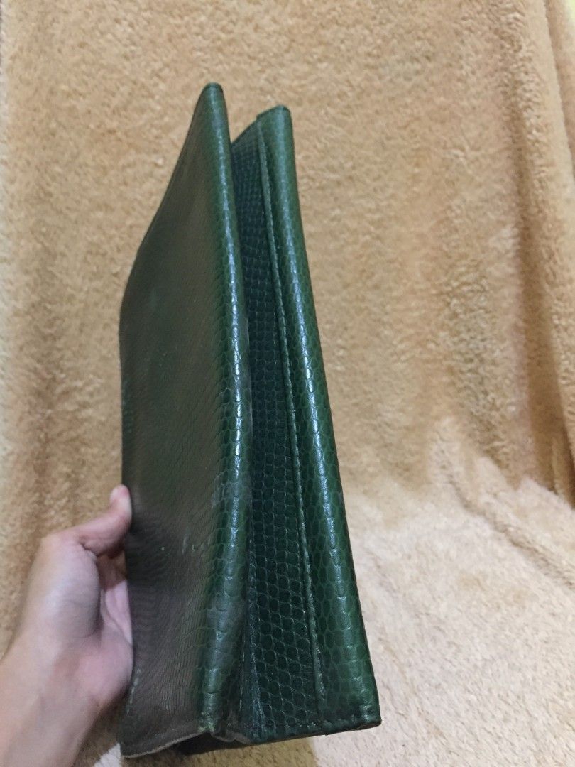 Moschino Green Wallet (Category: Luxury Bags & Wallets) located in Bulacan. Submitted by assorted.items (Listing ID 1397065296, Image 3). Description: - Authentic Moschino wallet - Green color with textured exterior - Features a flap closure with two gold-tone buttons - Interior includes: - Zippered pocket - Card slots - Unique black and white patterned lining - Comes with Moschino tag.