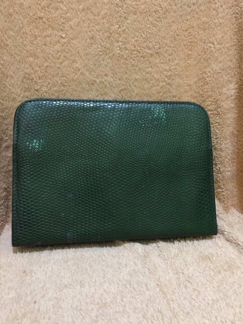 Moschino Green Wallet (Category: Luxury Bags & Wallets) located in Bulacan. Submitted by assorted.items (Listing ID 1397065296, Image 2). Description: - Authentic Moschino wallet - Green color with textured exterior - Features a flap closure with two gold-tone buttons - Interior includes: - Zippered pocket - Card slots - Unique black and white patterned lining - Comes with Moschino tag.