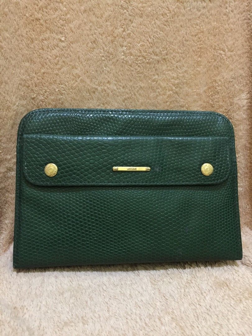 Moschino Green Wallet (Category: Luxury Bags & Wallets) located in Bulacan. Submitted by assorted.items (Listing ID 1397065296, Image 1). Description: - Authentic Moschino wallet - Green color with textured exterior - Features a flap closure with two gold-tone buttons - Interior includes: - Zippered pocket - Card slots - Unique black and white patterned lining - Comes with Moschino tag.