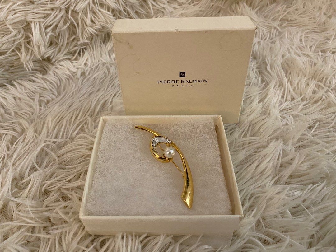 Pierre Balmain Paris Brooch (Category: Brooches) located in Manila. Submitted by star_section (Listing ID 1397158885, Image 3). Description: - Pierre Balmain Paris brooch - Gold-toned design - Features pearl and baguette-cut crystals - Comes with original box - Perfect for elevating any outfit.
