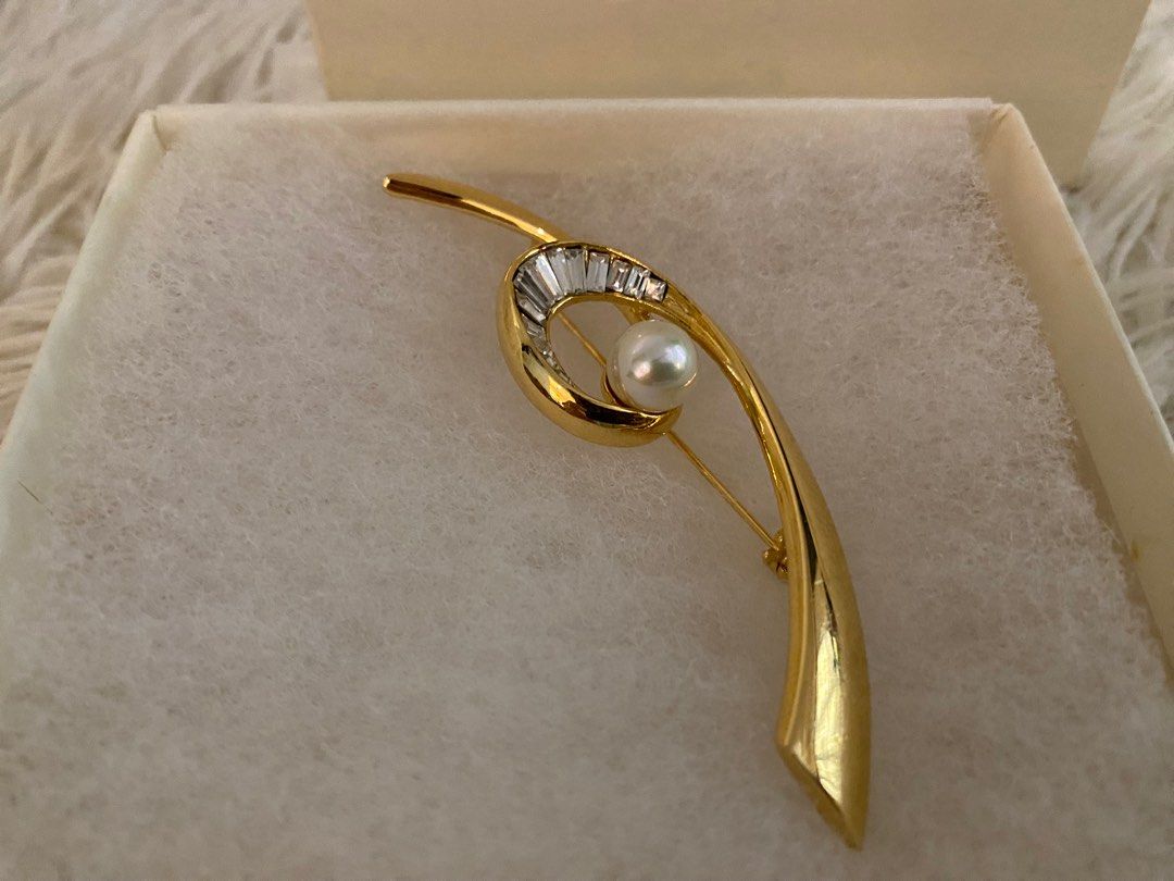 Pierre Balmain Paris Brooch (Category: Brooches) located in Manila. Submitted by star_section (Listing ID 1397158885, Image 1). Description: - Pierre Balmain Paris brooch - Gold-toned design - Features pearl and baguette-cut crystals - Comes with original box - Perfect for elevating any outfit.