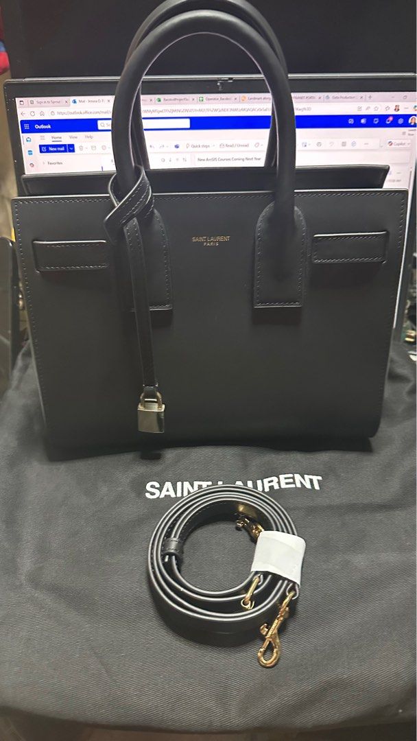 Saint Laurent Sac de Jour Handbag (Category: Luxury Bags & Wallets) located in Taytay. Submitted by jp4_fashion_hub (Listing ID 1397069356, Image 1). Description: - Saint Laurent Sac de Jour handbag - Color: Black - Includes a detachable shoulder strap - Features gold-tone hardware - Interior zippered pocket - Protective metal feet on the bottom - Includes a dust bag - Saint Laurent logo and code inside Replace lock Missing lock cover pouch Authe