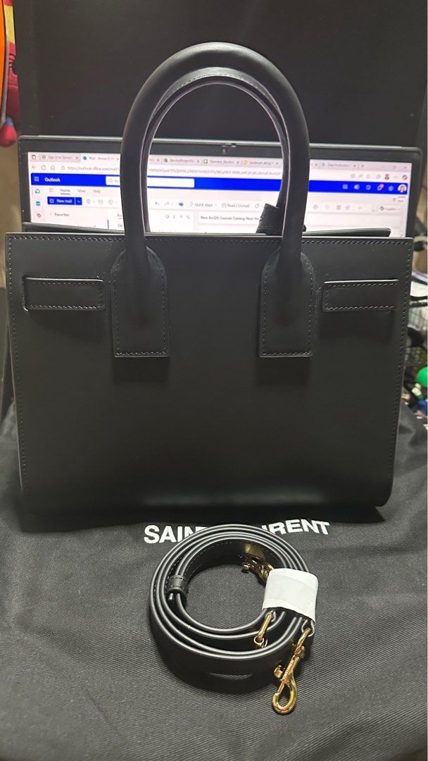 Saint Laurent Sac de Jour Handbag (Category: Luxury Bags & Wallets) located in Taytay. Submitted by jp4_fashion_hub (Listing ID 1397069356, Image 2). Description: - Saint Laurent Sac de Jour handbag - Color: Black - Includes a detachable shoulder strap - Features gold-tone hardware - Interior zippered pocket - Protective metal feet on the bottom - Includes a dust bag - Saint Laurent logo and code inside Replace lock Missing lock cover pouch Authe