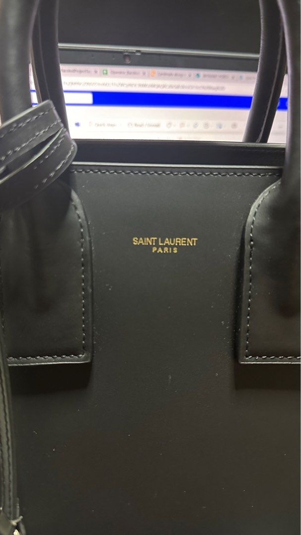 Saint Laurent Sac de Jour Handbag (Category: Luxury Bags & Wallets) located in Taytay. Submitted by jp4_fashion_hub (Listing ID 1397069356, Image 3). Description: - Saint Laurent Sac de Jour handbag - Color: Black - Includes a detachable shoulder strap - Features gold-tone hardware - Interior zippered pocket - Protective metal feet on the bottom - Includes a dust bag - Saint Laurent logo and code inside Replace lock Missing lock cover pouch Authe