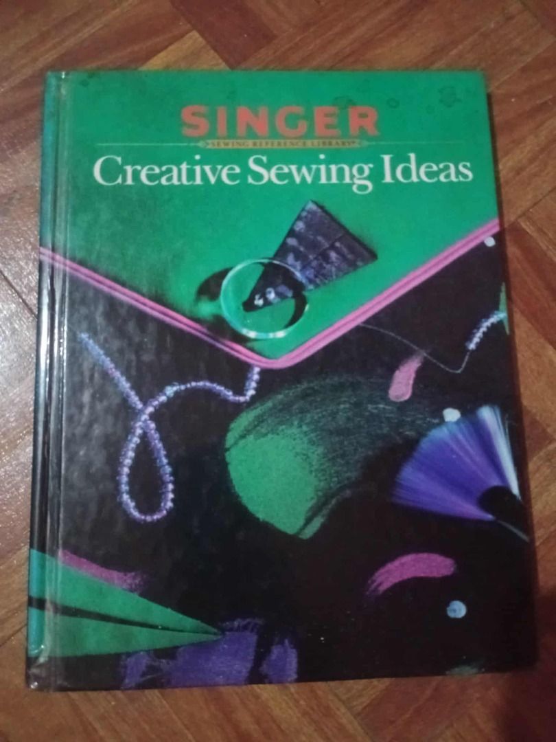 Singer Creative Sewing Ideas Book (Category: Magazines) located in Manila. Submitted by sec0ndbloom (Listing ID 1397049812, Image 1). Description: - Singer Creative Sewing Ideas book - Contains sewing projects and ideas - Includes illustrations and instructions - Guide for various sewing techniques - Features a green cover with the Singer logo.
