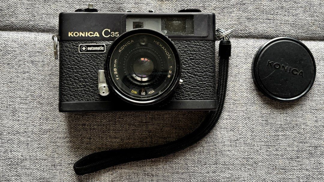 Vintage Konica C35 Automatic Film Camera (Category: Cameras) located in Manila. Submitted by _minimalist__ (Listing ID 1397039132, Image 1). Description: - Konica C35 Automatic film camera - Black color - Includes original box, lens cap, strap, and case - Features a Hexanon f2.8 lens - Comes with original documents - Made in Japan.