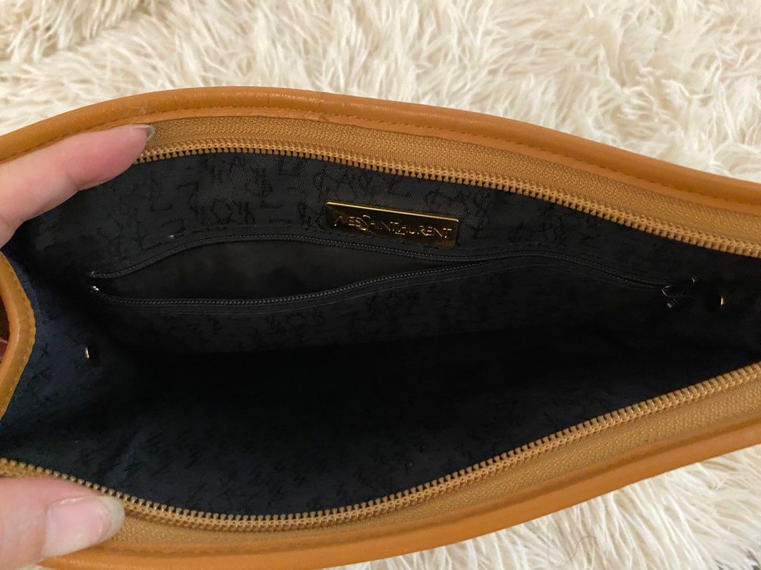 Yves Saint Laurent Clutch Bag (Category: Clutches) located in Manila. Submitted by star_section (Listing ID 1397160012, Image 3). Description: - Vintage Yves Saint Laurent clutch bag - Black woven exterior - Tan leather flap and trim - Gold-tone YSL logo - Zipper closure - Black fabric interior with small pocket.
