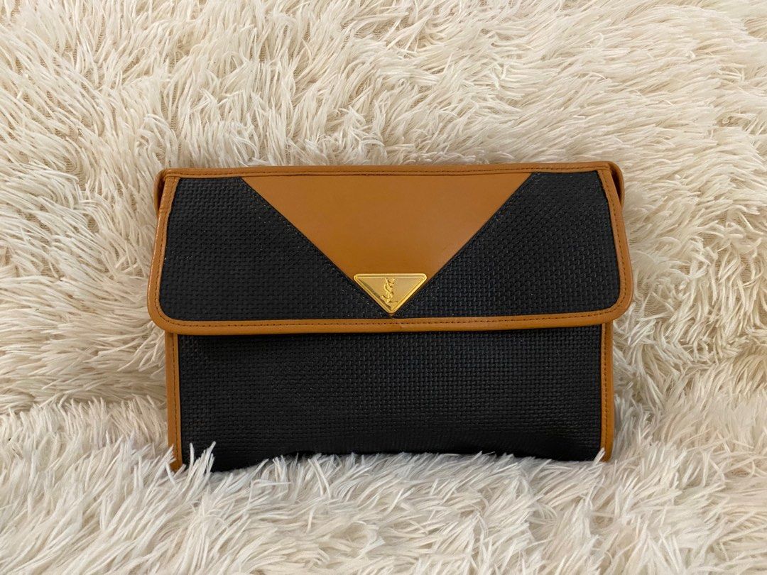 Yves Saint Laurent Clutch Bag (Category: Clutches) located in Manila. Submitted by star_section (Listing ID 1397160012, Image 1). Description: - Vintage Yves Saint Laurent clutch bag - Black woven exterior - Tan leather flap and trim - Gold-tone YSL logo - Zipper closure - Black fabric interior with small pocket.