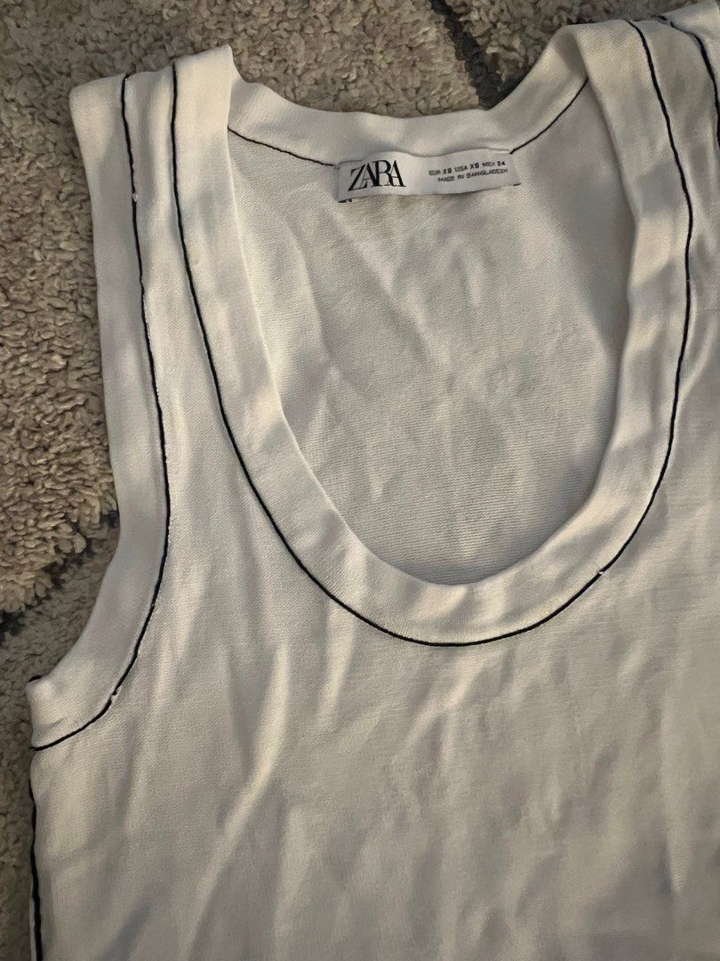 Zara White Contrast Stitch Tank (Category: Sleeveless) located in Quezon. Submitted by lovdogs (Listing ID 1397098789, Image 3). Description: - Zara white tank top - Black stitching details - Round neckline - Ribbed hem - Size: XS - Made in Bangladesh.