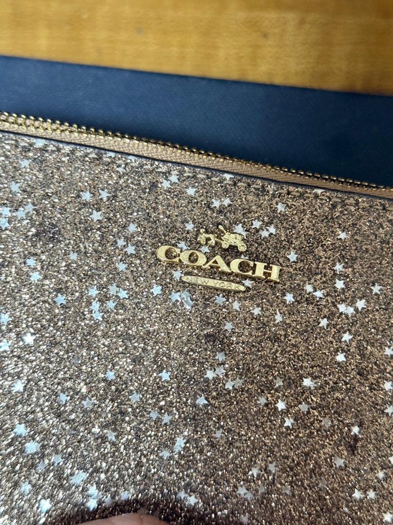 Coach Wristlet (Category: Luxury Bags & Wallets) located in Quezon City. Submitted by beabeys (Listing ID 1397331080, Image 2). Description: - Coach wristlet - Gold glitter design - Zip closure - Wrist strap - Multiple card slots - Includes original box - Made in Vietnam.